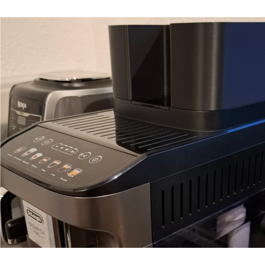 Black and silver coffee machine with control panel on a light background
