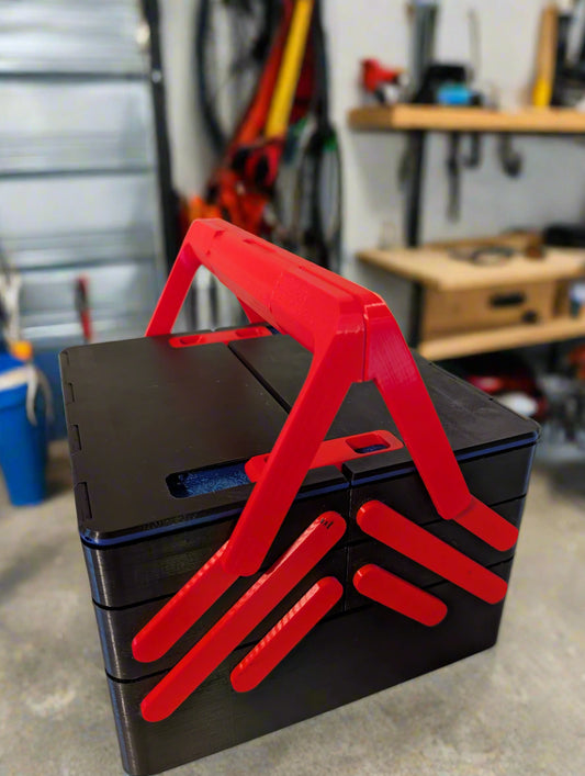 Black toolbox with red handles on a white surface