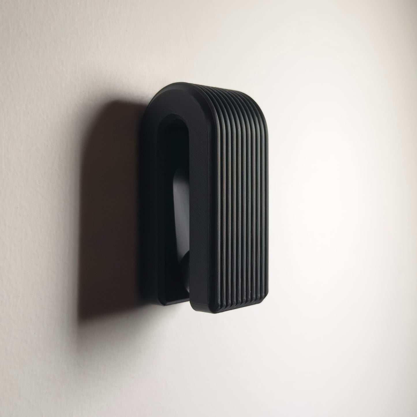 Black door handle on a white wall