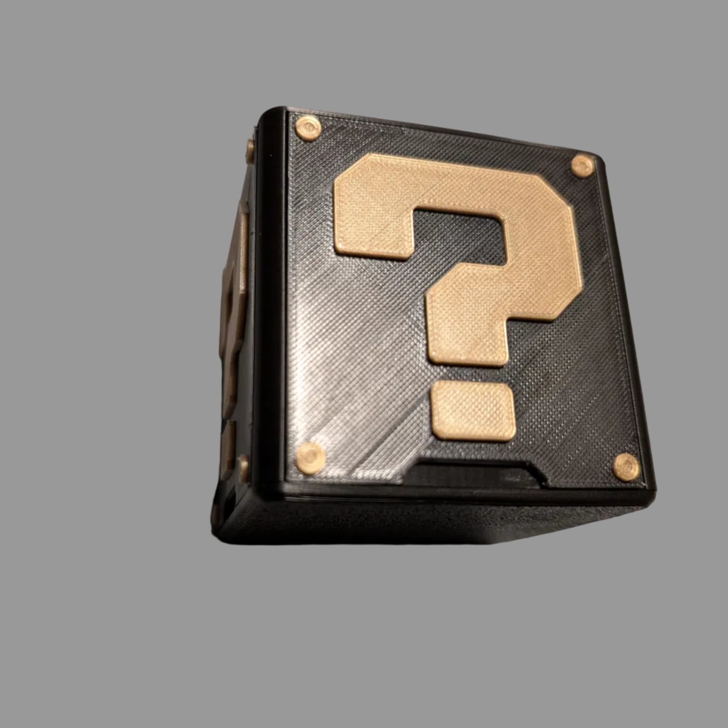 Black and gold question mark block on a gray background